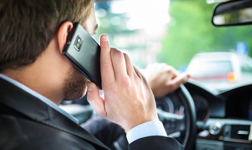 Man talking on the phone on his car